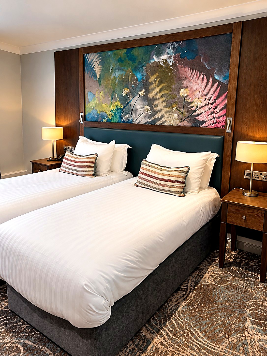 Hotel bedroom with printed fern headboard panel